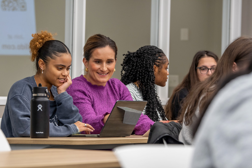 Associate Professor Diana Sobieraj talking with students in the classroom at the School of Pharmacy