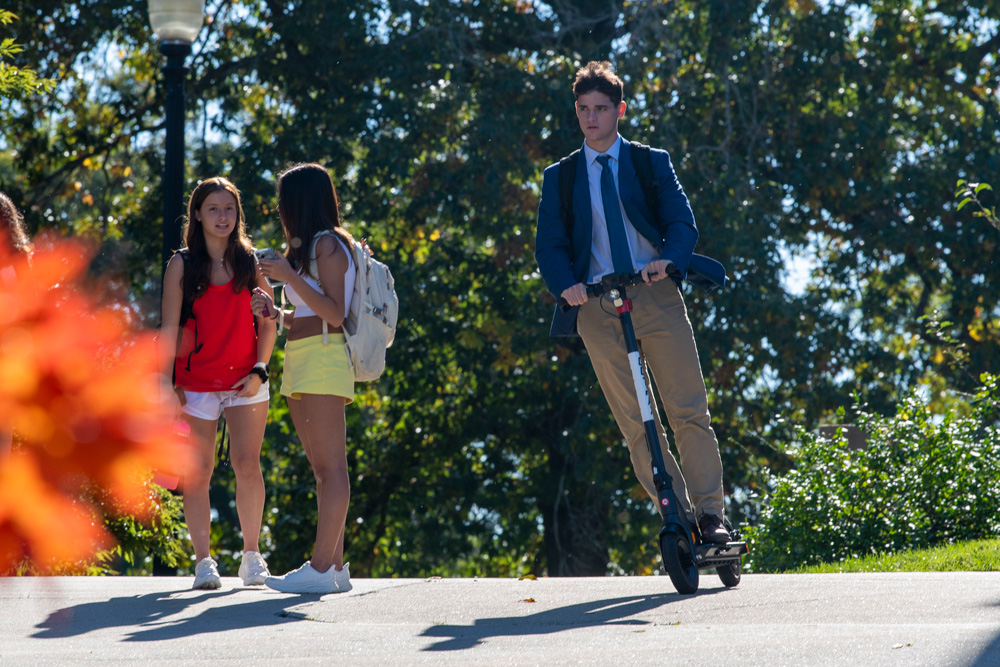 Students walking across campus during the fall.